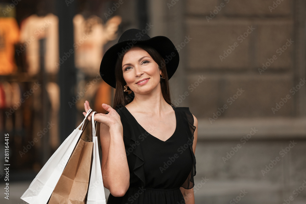 Beautiful woman with shopping bags outdoors