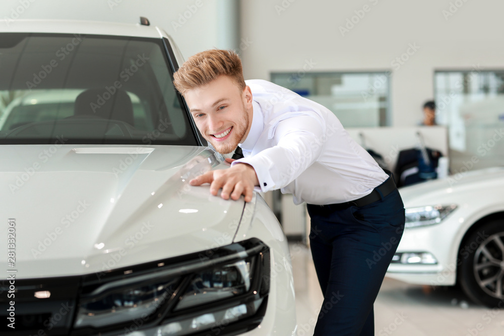 Man choosing new car in salon