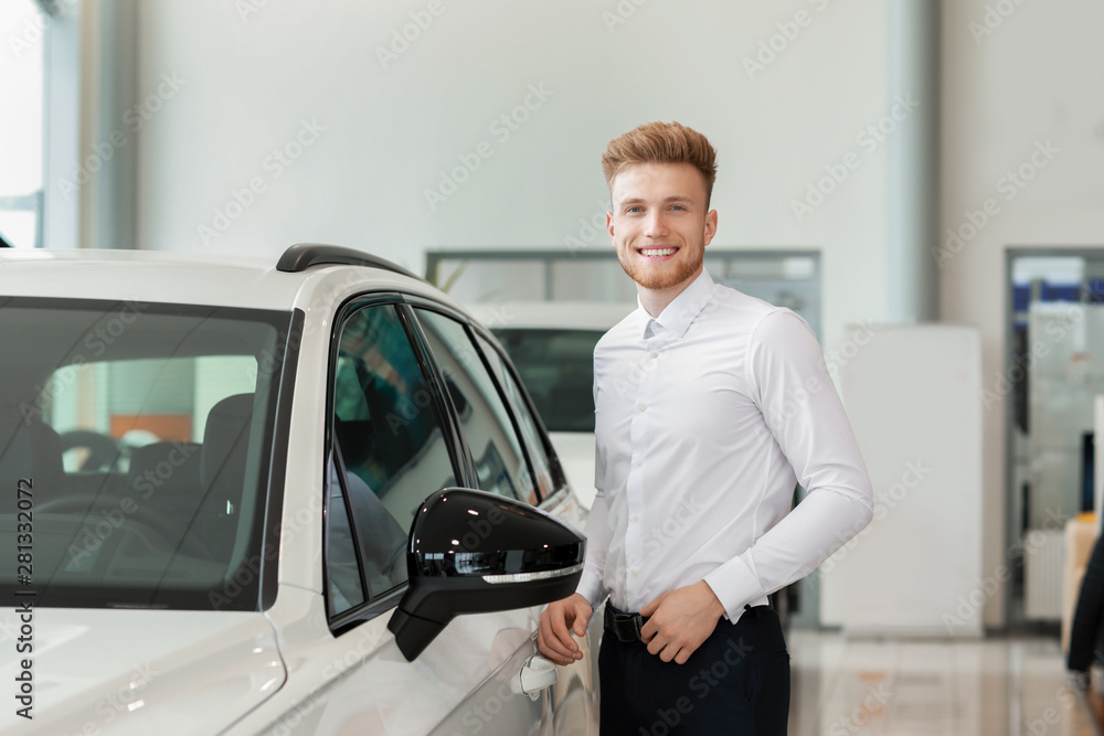 Man choosing new car in salon