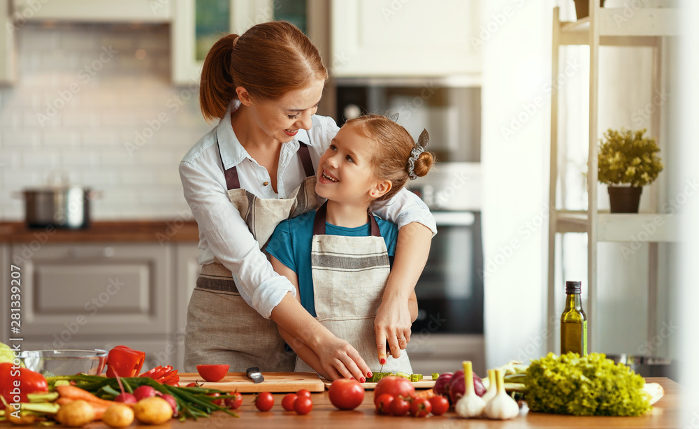 happy family mother with child girl preparing vegetable salad .