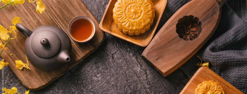 中秋节传统美食理念-黑石板桌上的漂亮月饼配茶，啪