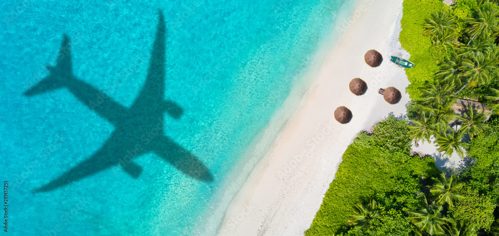 Travel concept with airplane shadow and beach