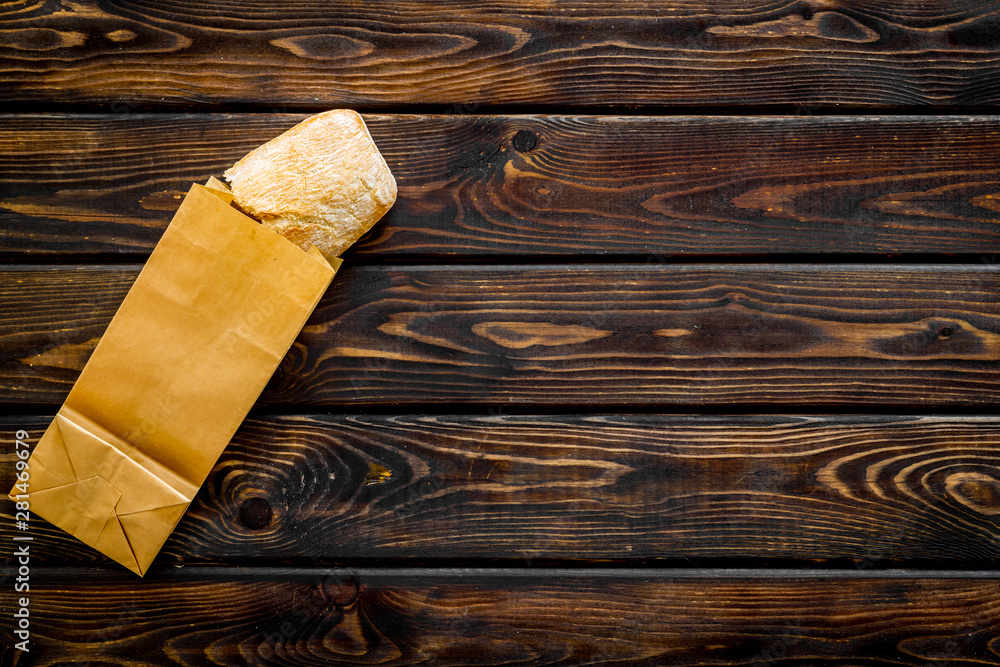 Bakery with fresh french baguette loaf on wooden background top view mockup