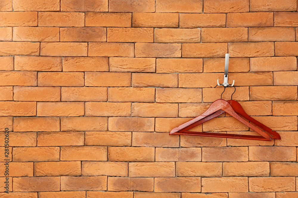 Clothes hangers on brick wall