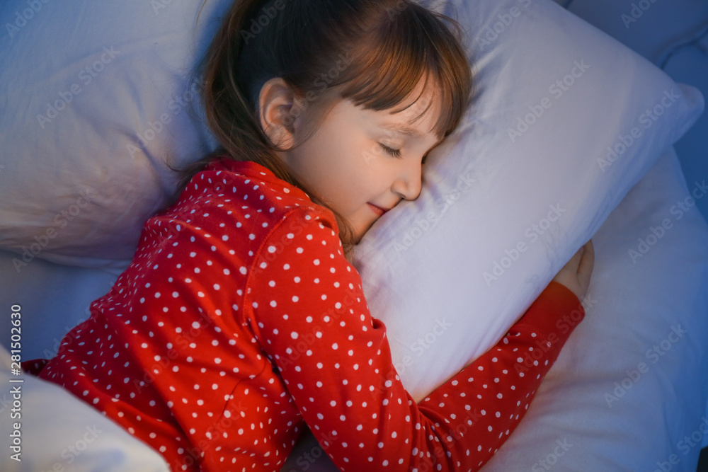 Cute little girl sleeping in bed at night