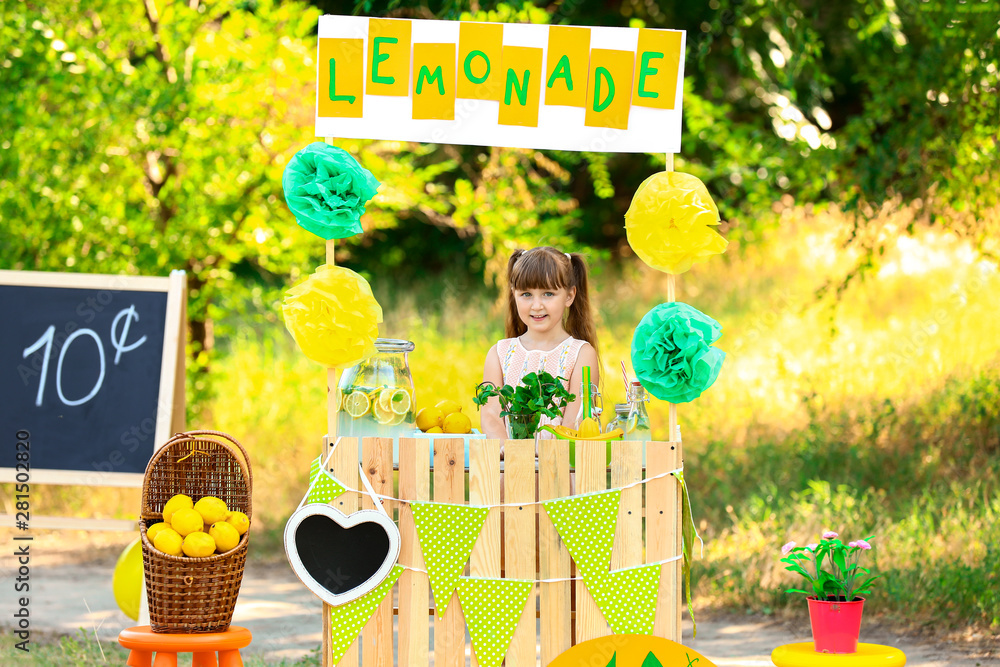 Cute little girl at lemonade stand in park