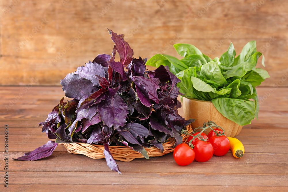 Different fresh herbs with vegetables on wooden table