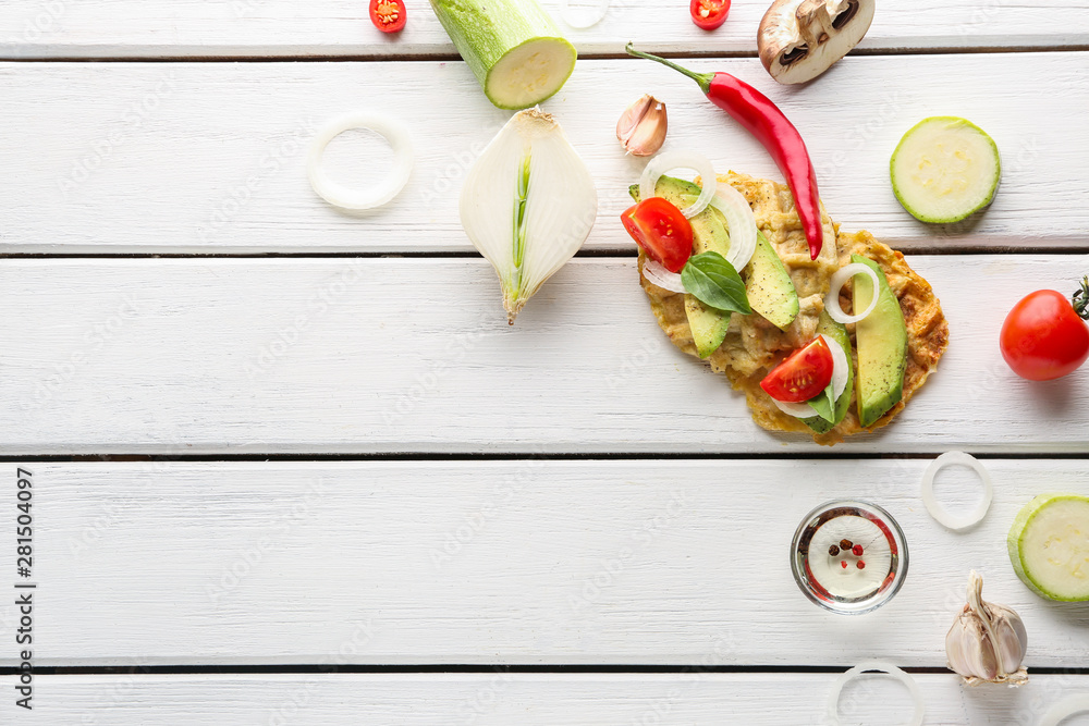 Tasty waffles with vegetables on white wooden background