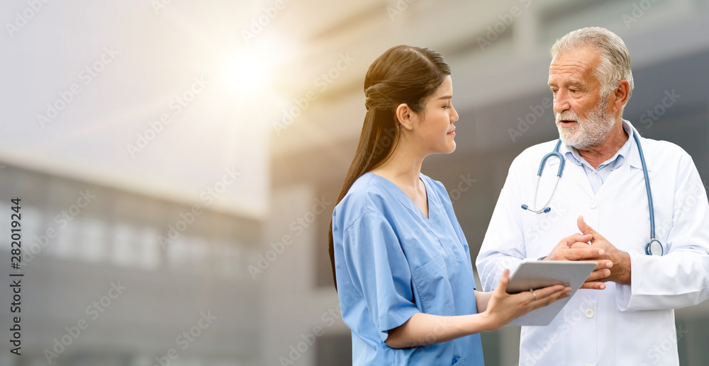 Senior doctor working with young doctor in the hospital. Medical healthcare staff and doctor service