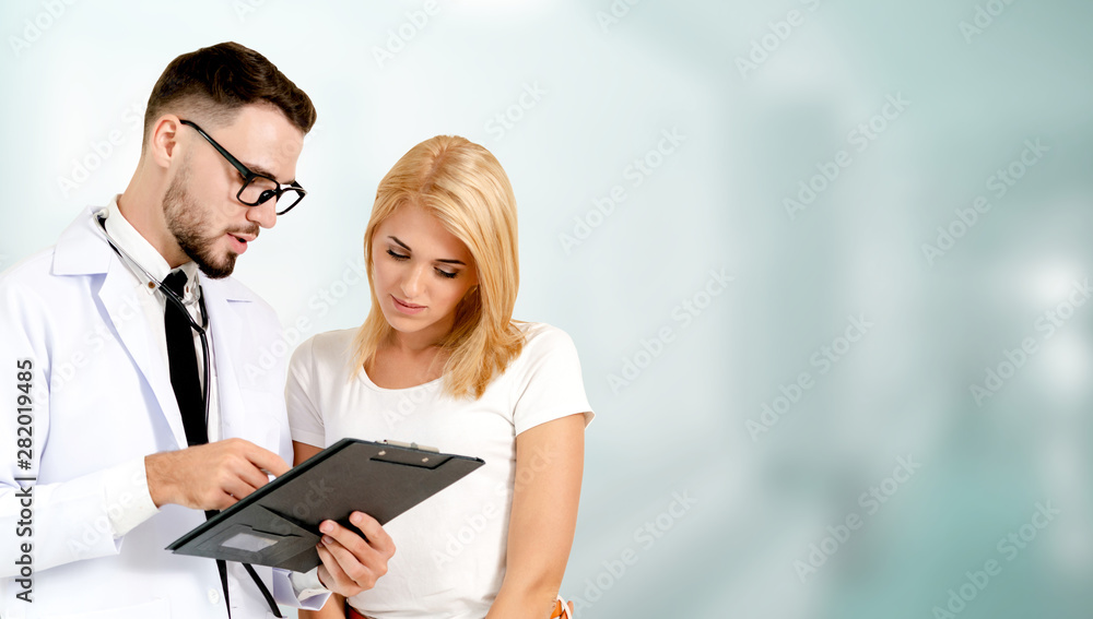 Doctor talking to patient in the hospital. The happy patient is listening to explanation from the do