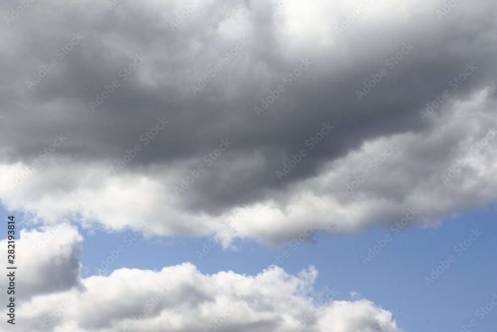 Blue sky with dark clouds background