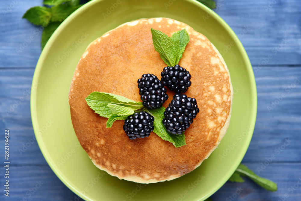 Tasty pancakes with blackberry on wooden table