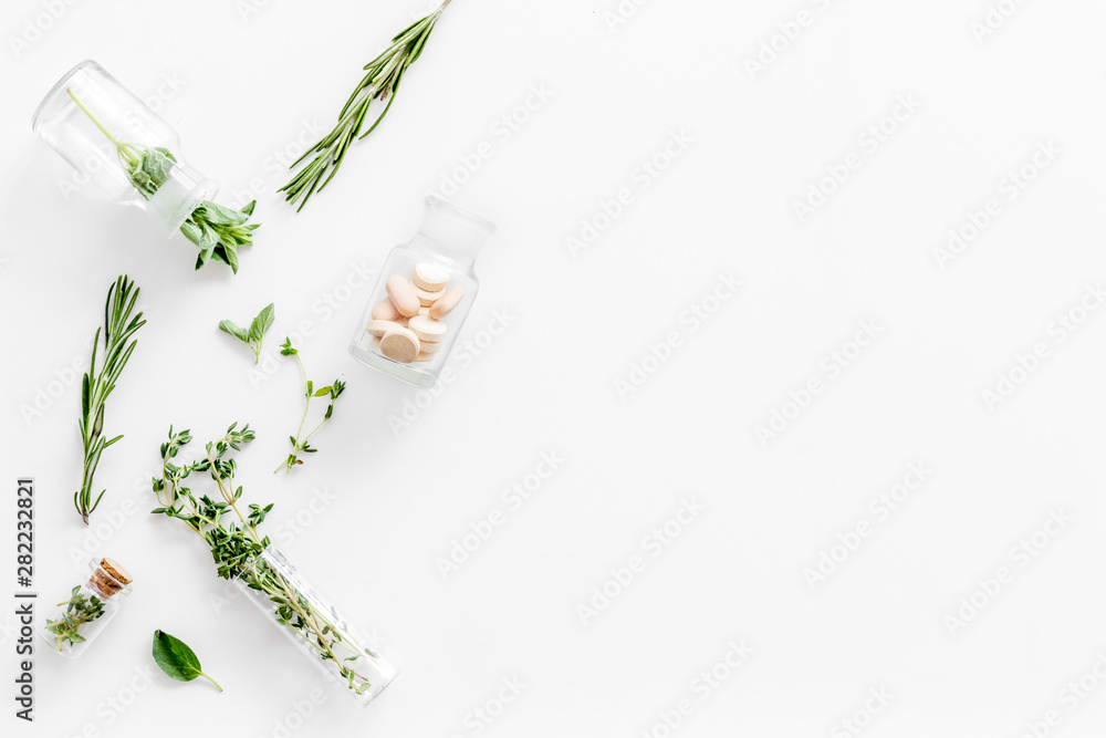 Alternative medicine with medicinal herbs and pills on white background top view mock up