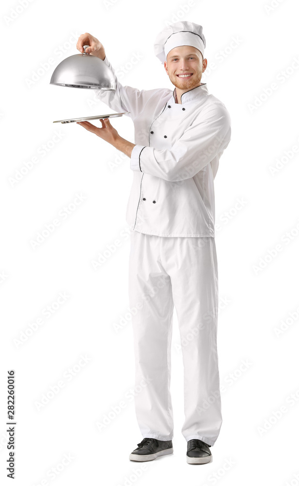 Handsome male chef with tray and cloche on white background