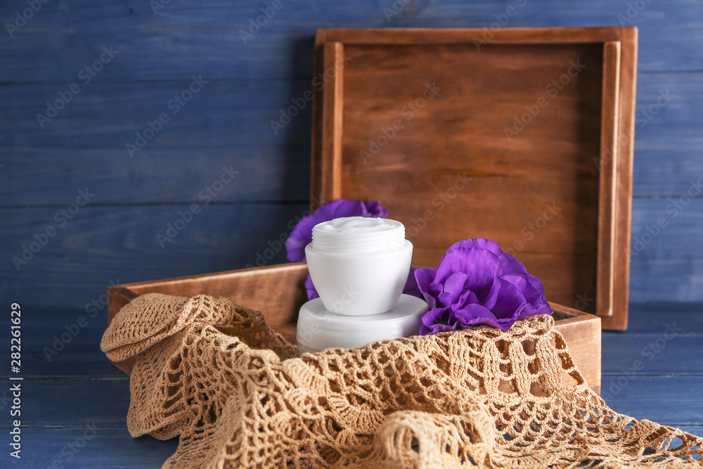 Box with body cream on table