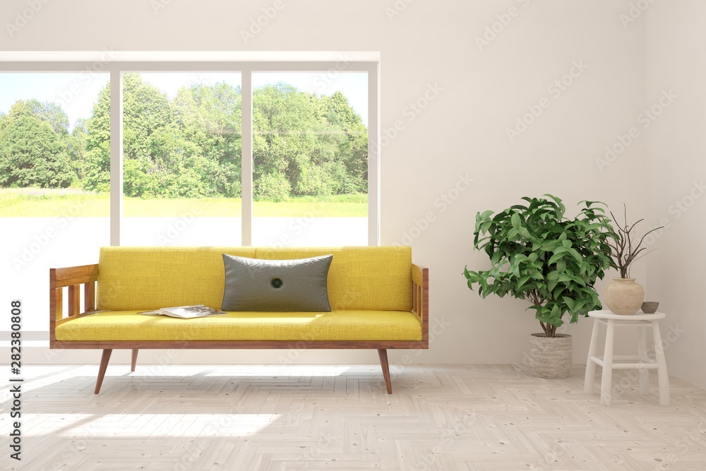 Stylish room in white color with sofa and summer landscape in window. Scandinavian interior design. 