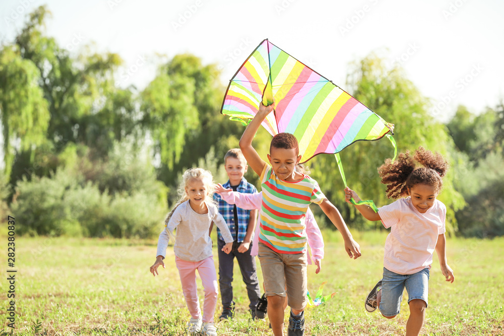 Group of happy children with kite in park