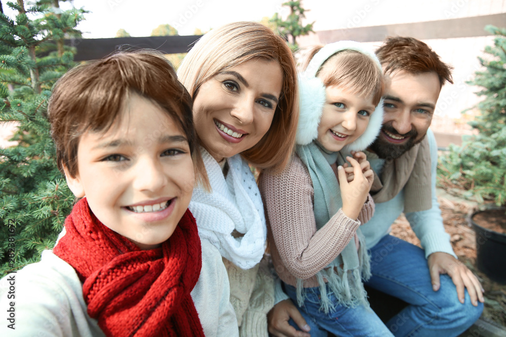 Family taking selfie at Christmas tree market