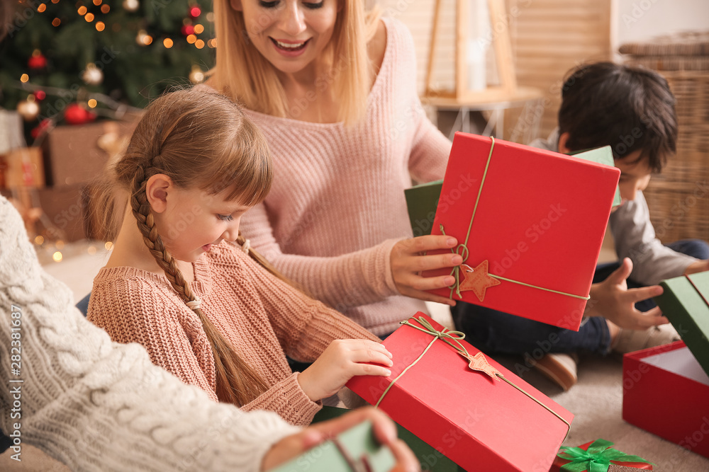 Happy family with Christmas gifts at home