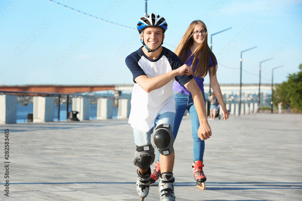 Teenagers on roller skates outdoors