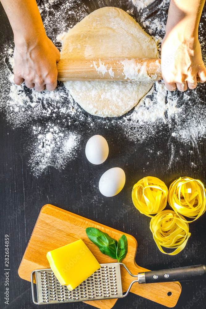 chef cooking pasta top view on dark background