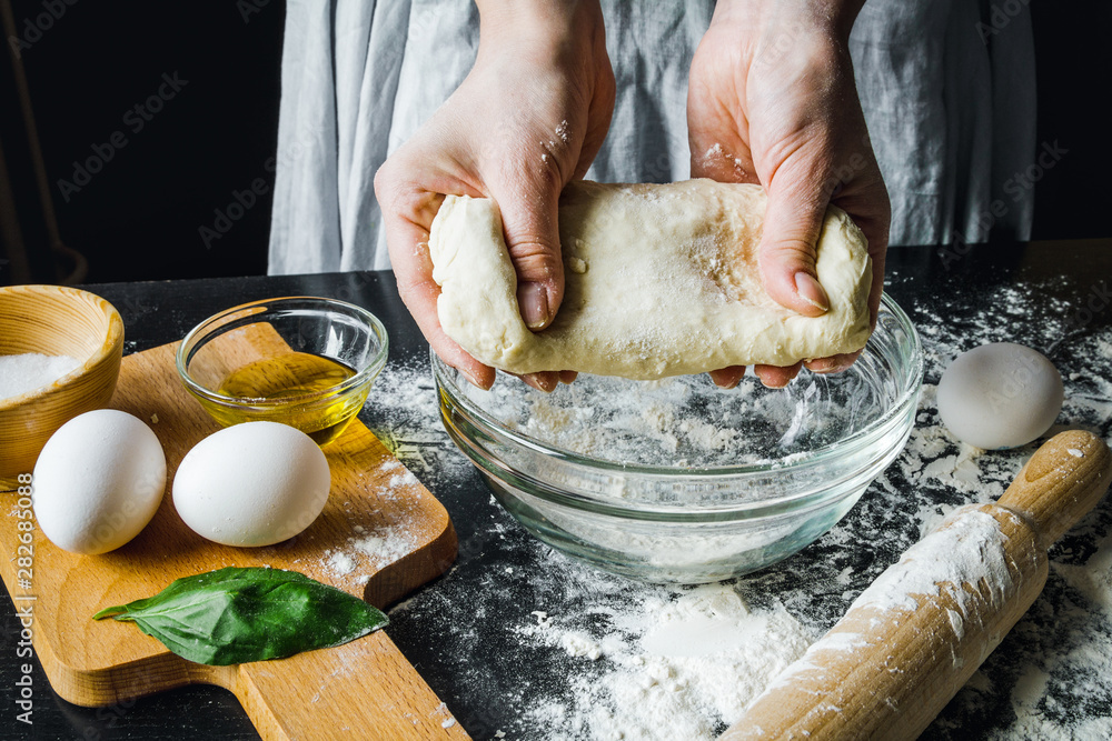 cooking pasta by chef in kitchen on dark background