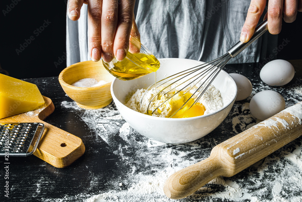 cooking pasta by chef in kitchen on dark background