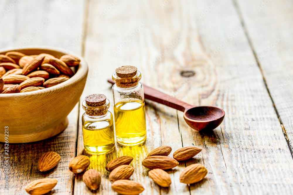 organic cosmetic with almond extract on table background