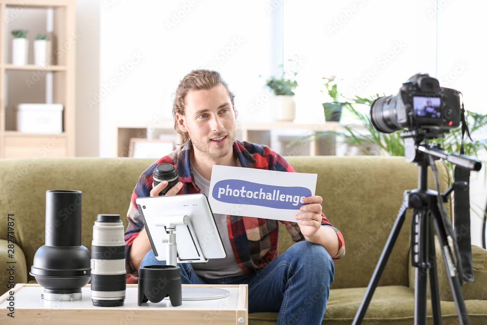 Male photographer recording video for his blog at home