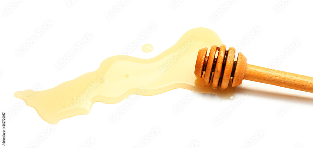 Wooden honey dipper on white background