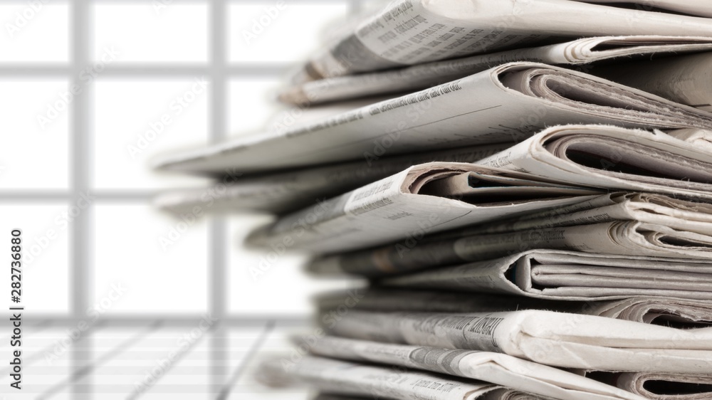 Pile of newspapers on white background