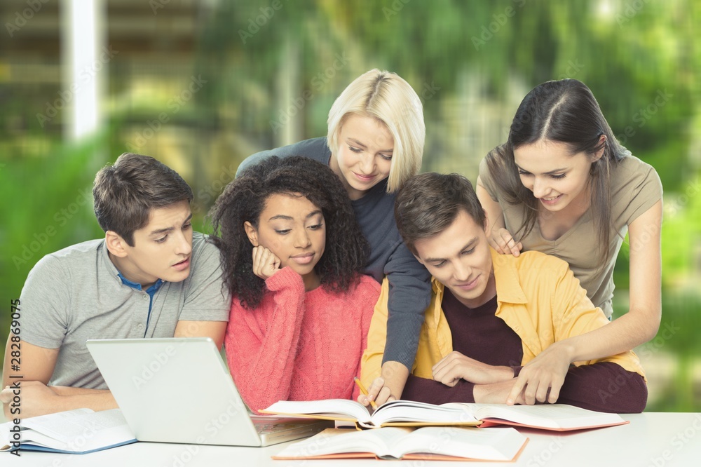 Four Young students studying subject on background