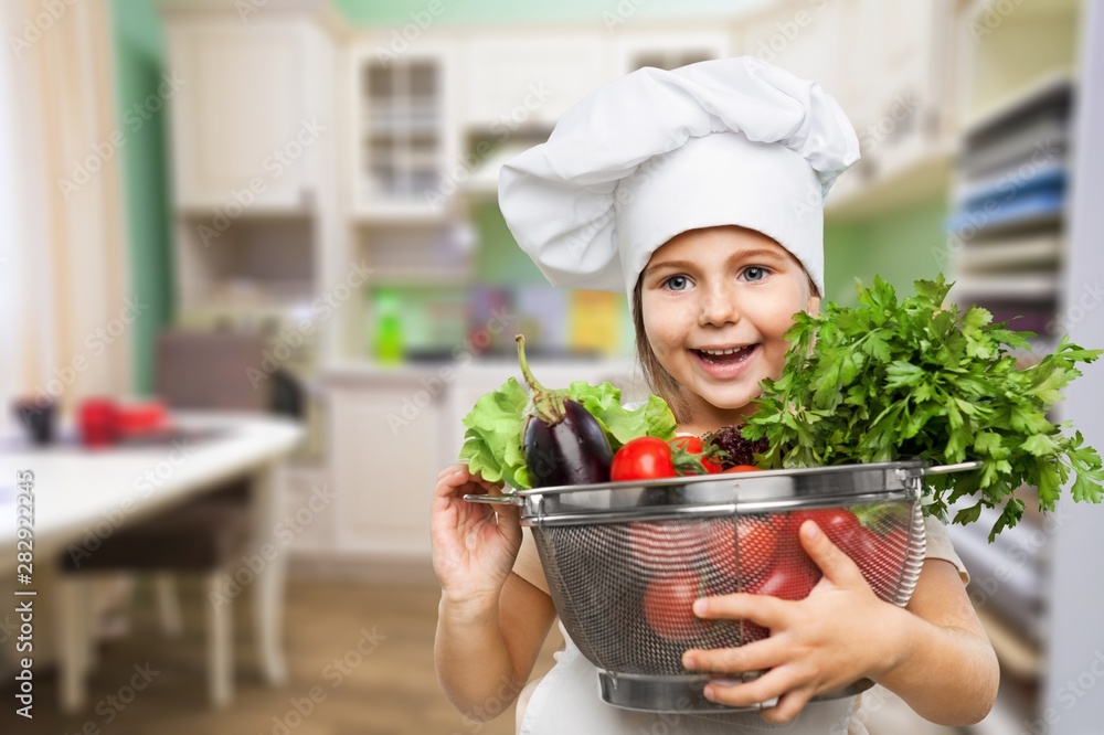 Portrait of adorable little girl preparing healthy food at kitchen