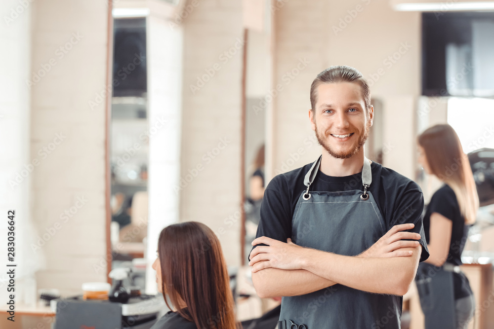 Portrait of male hairdresser in salon