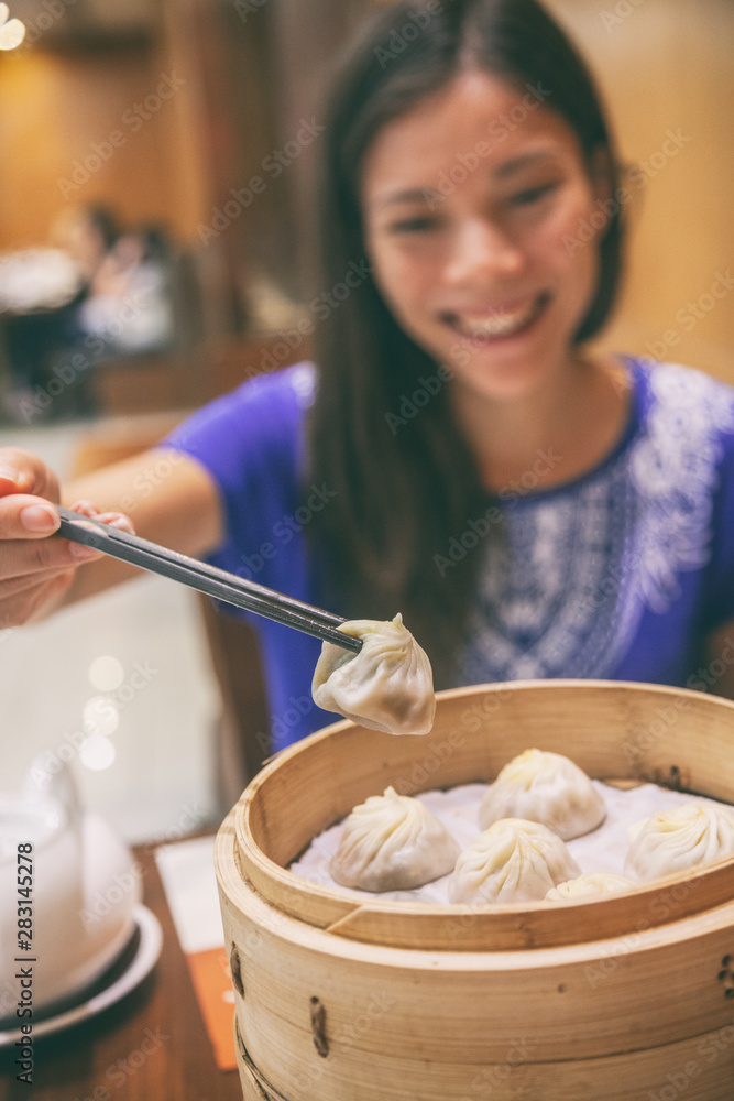 Chinese restaurant Asian woman eating xiao long bao dumplings steamed soup dumpling local food on As