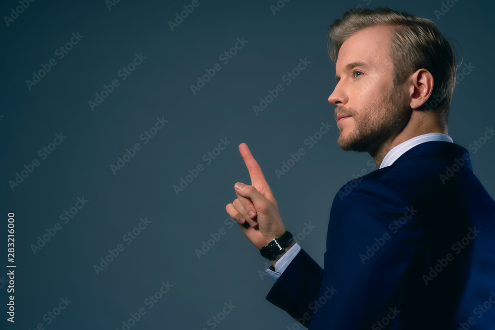 businessman hand point show one finger present invisible monitor screen isolate dark background