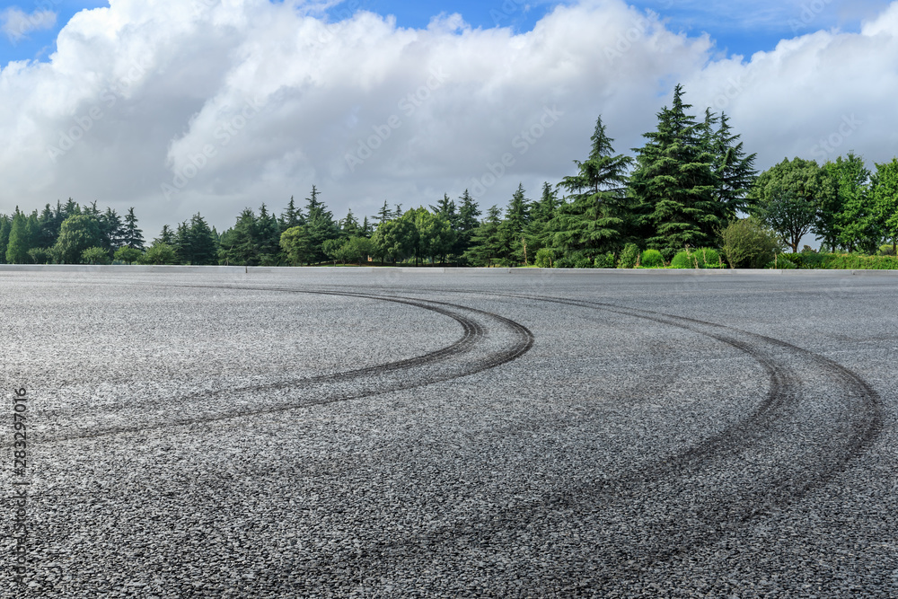 Asphalt race track and green woods nature landscape in summer