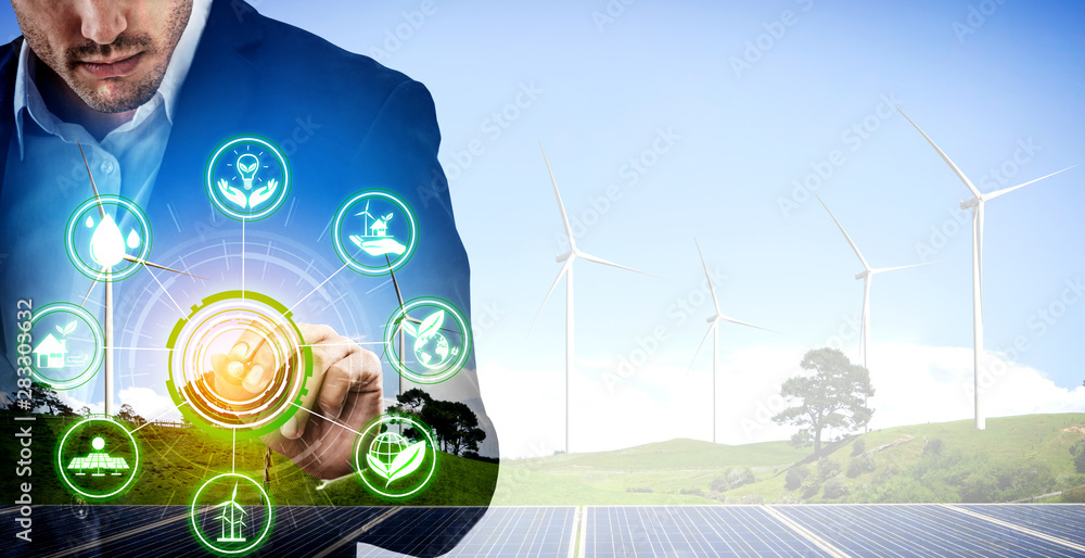 Double exposure graphic of business people working over wind turbine farm and green renewable energy