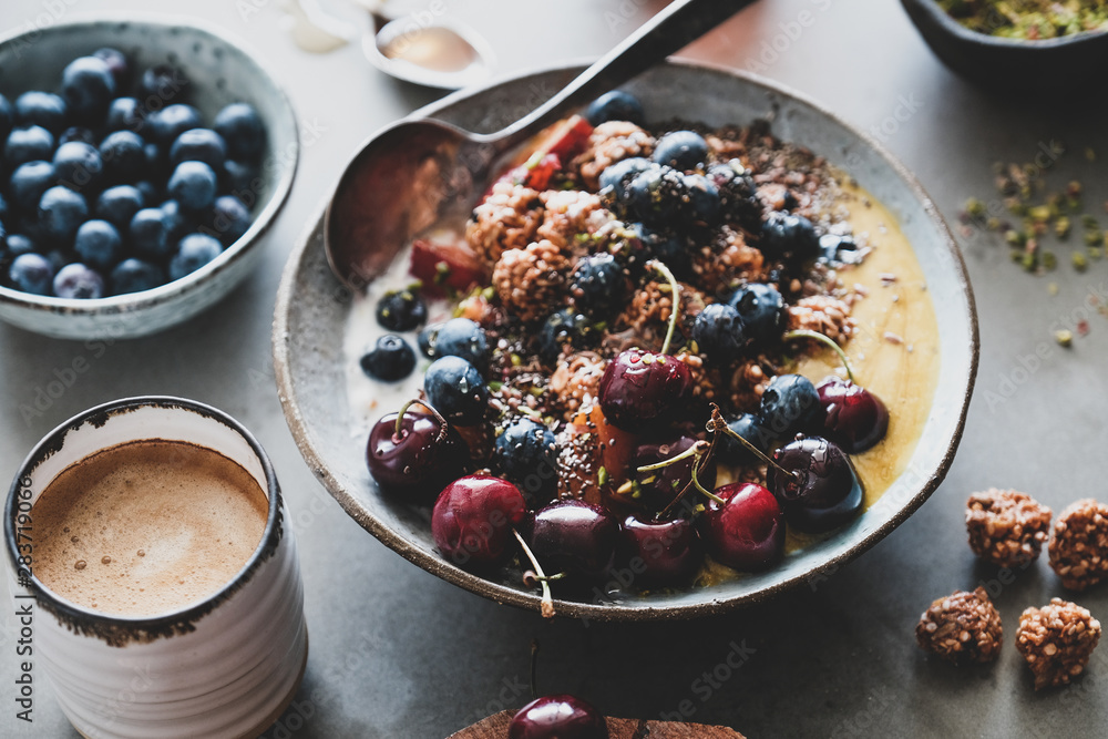 Healthy vegan breakfast set. Quinoa oat granola coconut yogurt bowl with fruit, seeds, nuts, berries