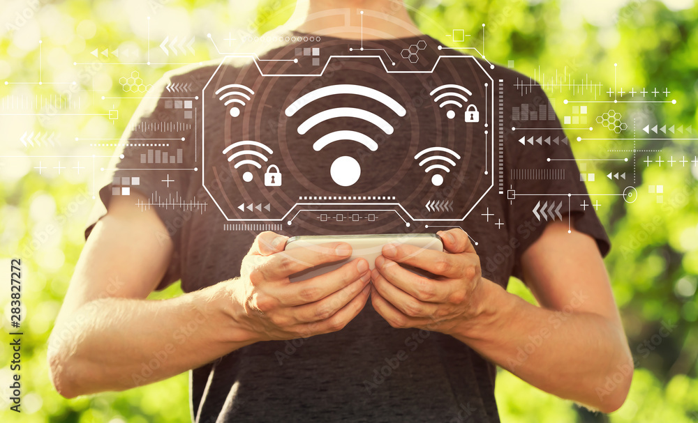 Wifi with young man holding his smartphone outside