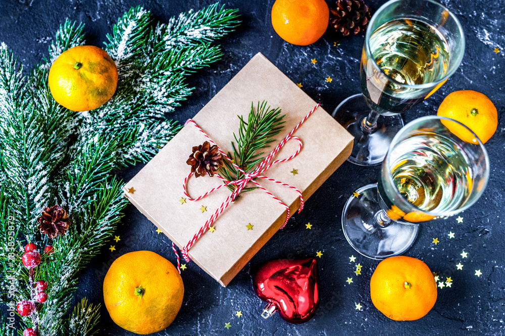 glasses and Christmas ornaments on dark background top view