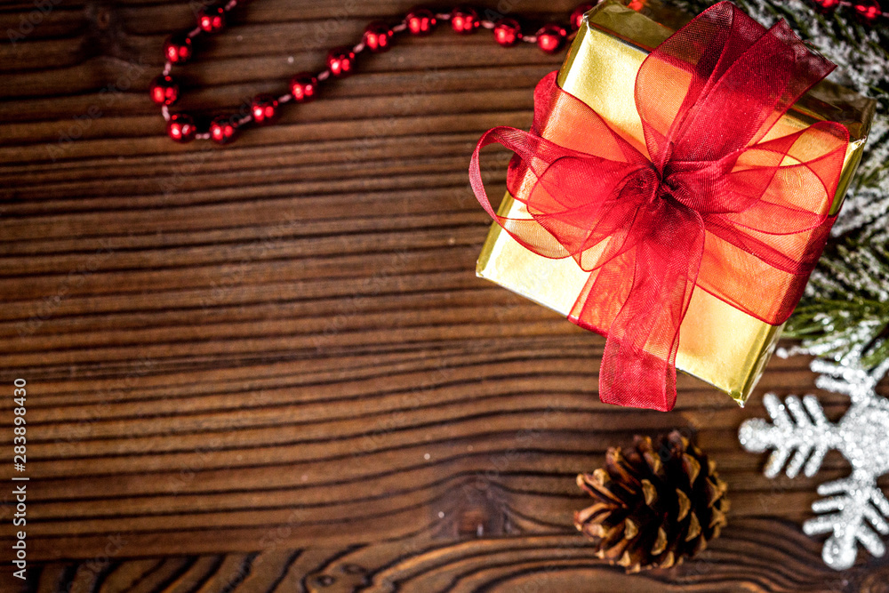 gifts boxes with fir branches on wooden background top view