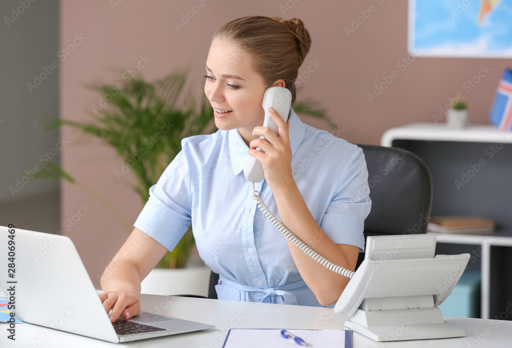 Female travel agent working in office