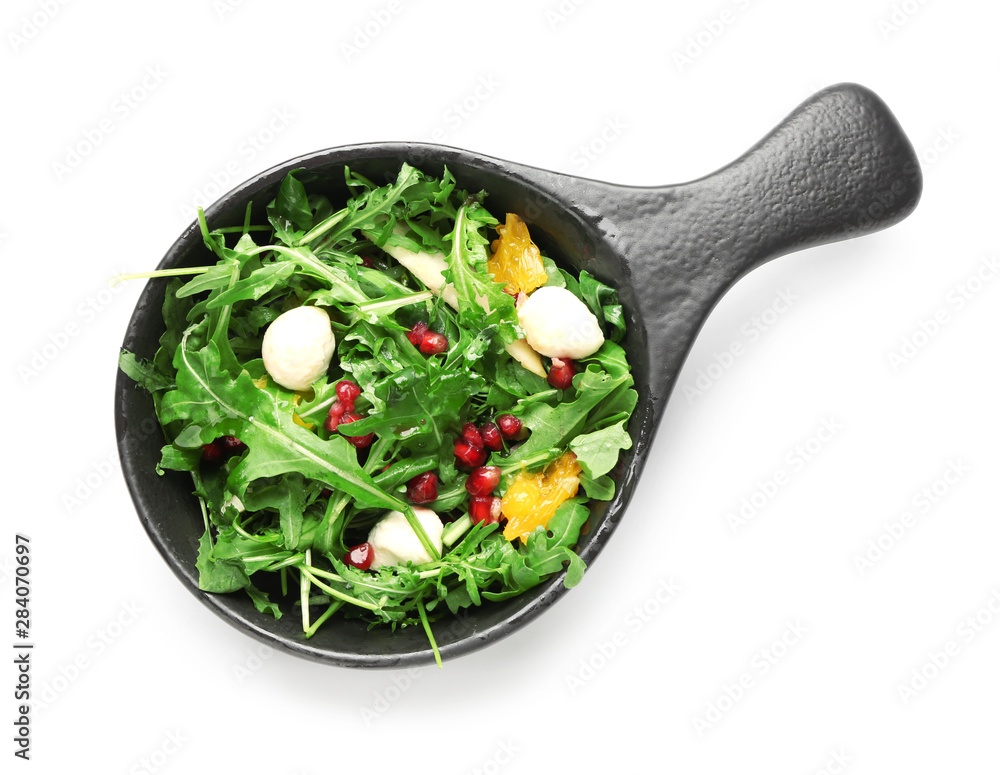 Bowl with tasty arugula salad on white background