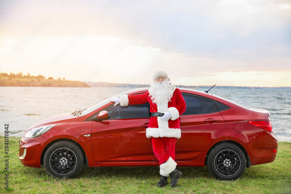 Santa Claus near car on riverside