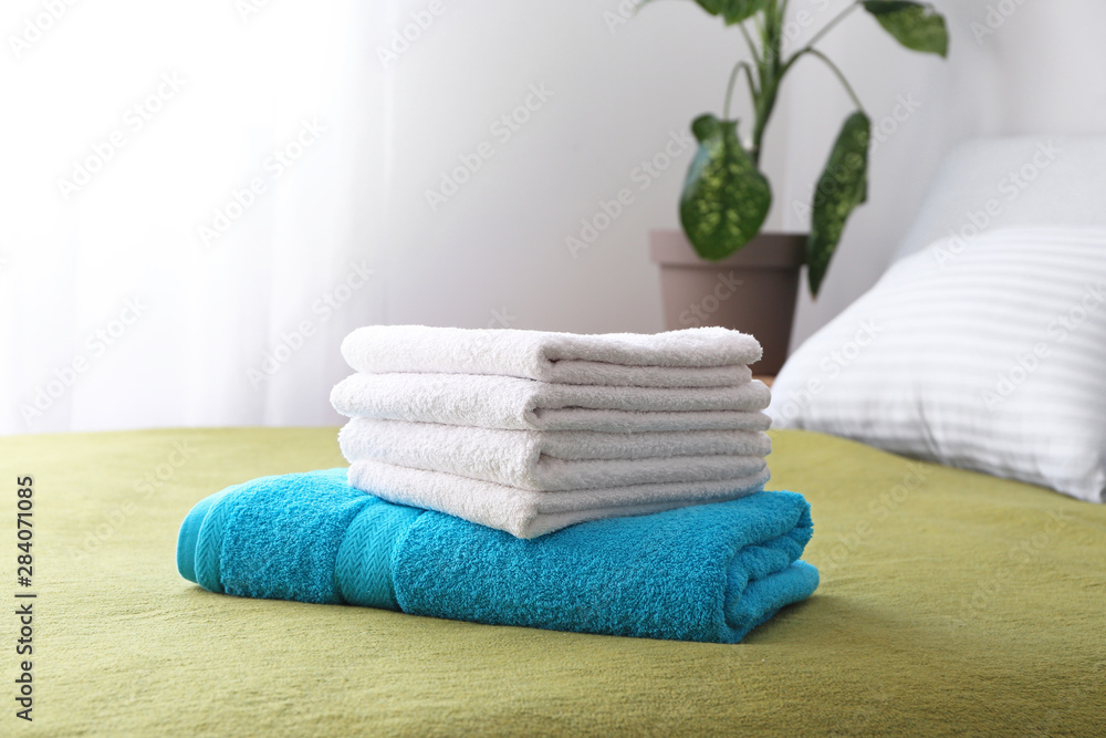 Clean soft towels on bed