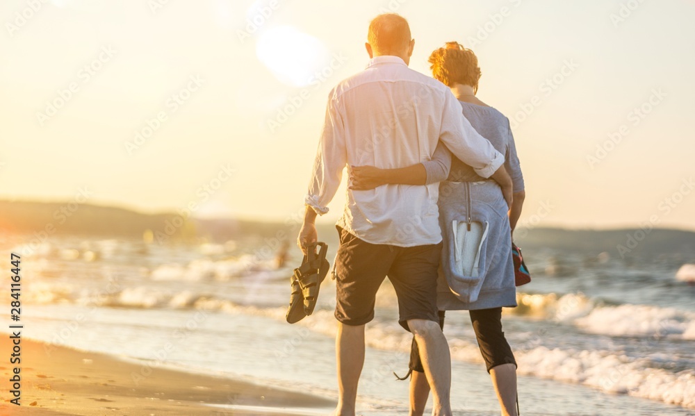 Close-up portrait of an elderly couple hugging on seacoast