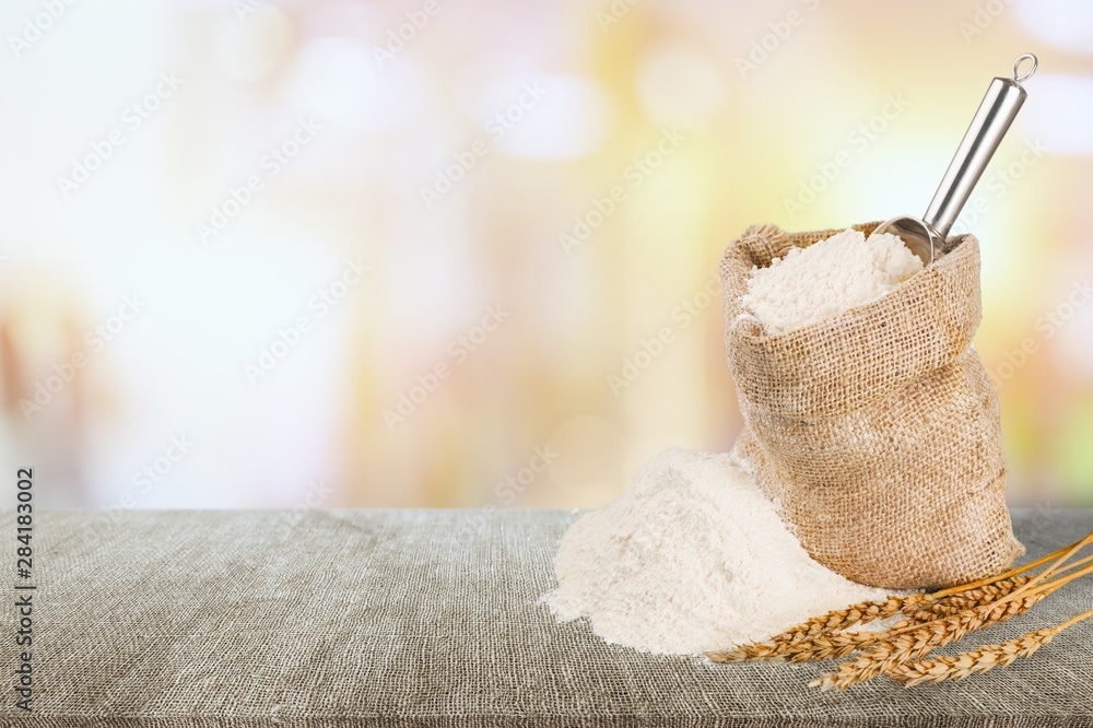 Wheat ears and flour on  background