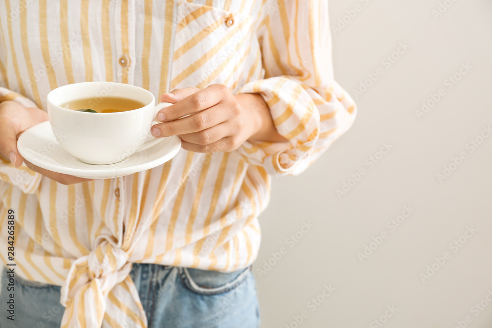 Woman holding cup of hot tea, closeup