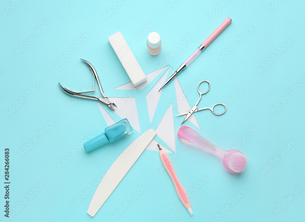 Supplies for manicure and pedicure on color background